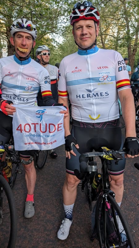 Stuart Storey (left) and Piotr Wojda stand with their bikes and 40tude flag at the 2023 RideLondon-Essex 100