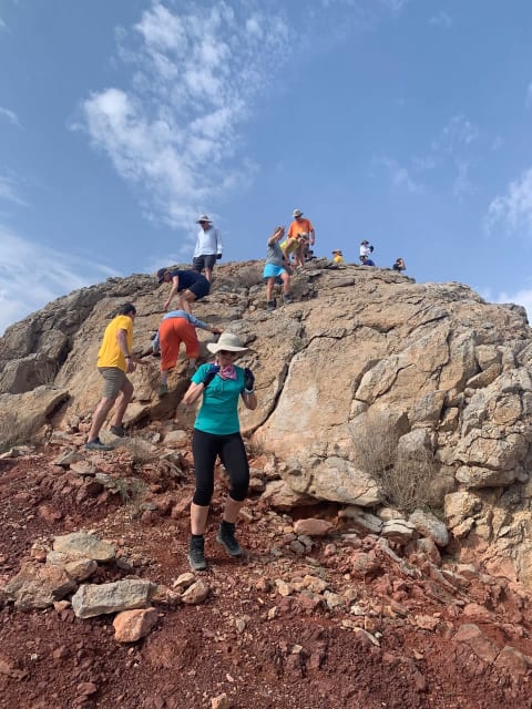 40tuders scrambling rocks in Oman